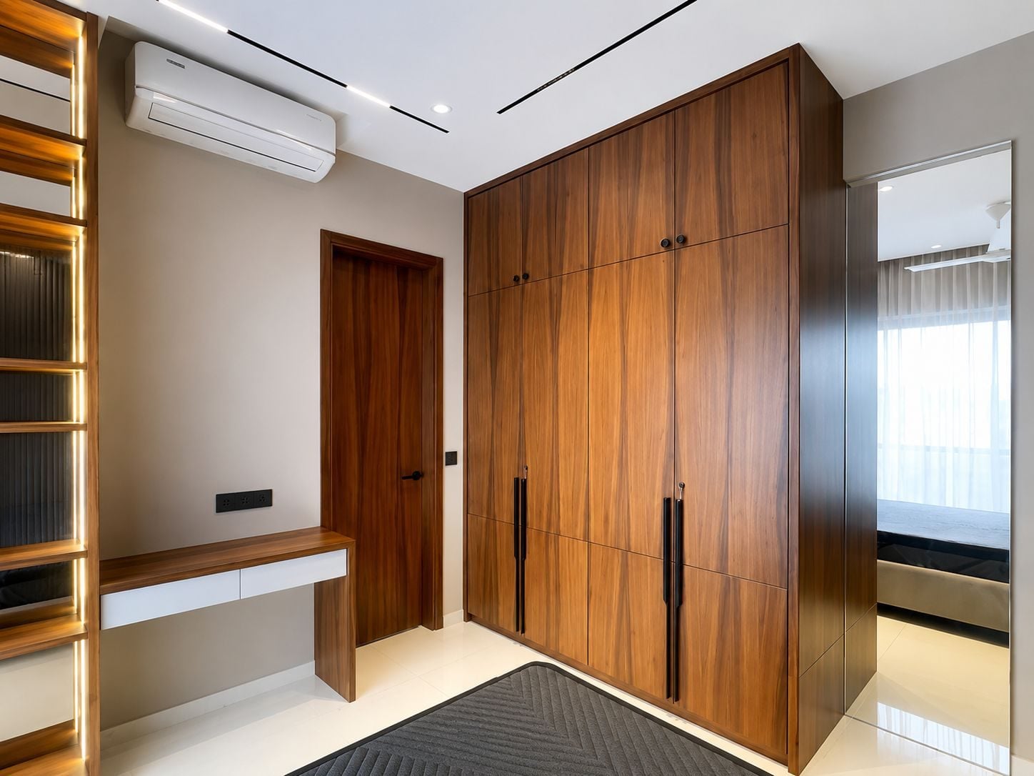 Bedroom with a walnut wardrobe wall and built-in study desk